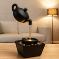 Teapot Water Fountain Lamp, Black Resin Hanging Pot Waterfall with Warm LED Glow and Pebble Bed for Home Office and Meditation Corner Decor
